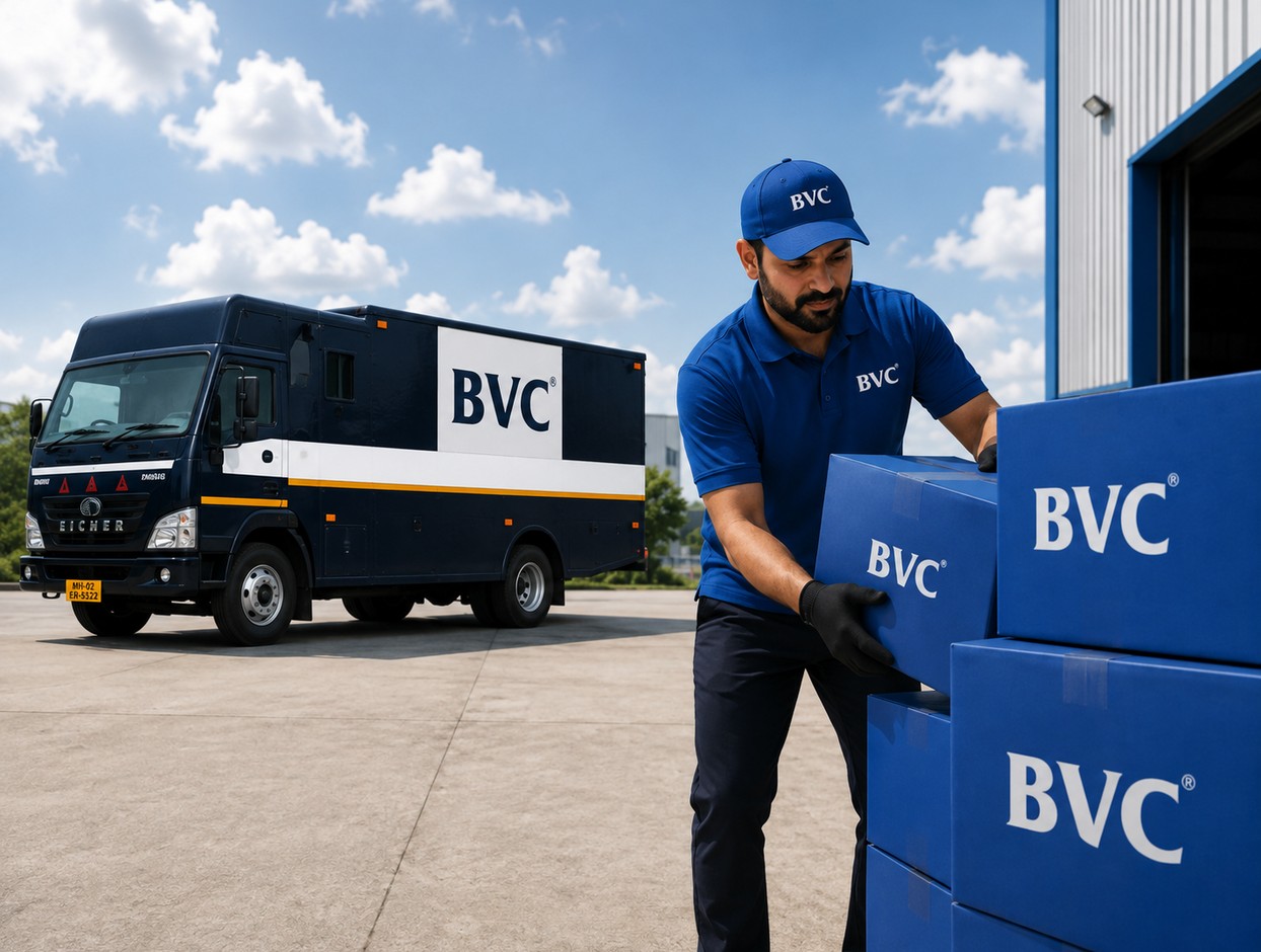 A BVC team member stacking sealed BVC boxes beside a BVC container truck at a facility